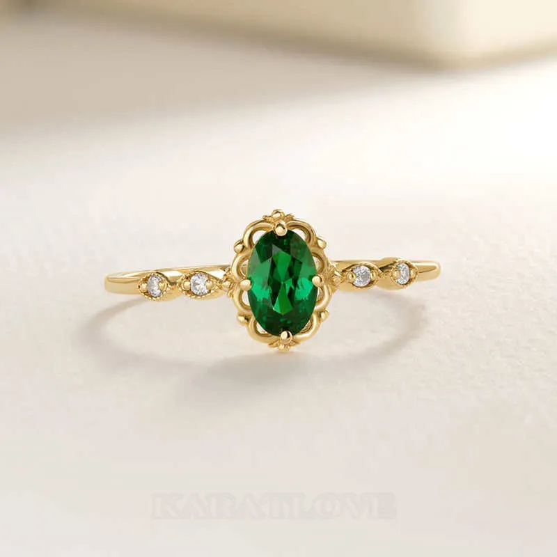 Bague de fiançailles en argent et or jaune avec émeraude verte de taille ovale