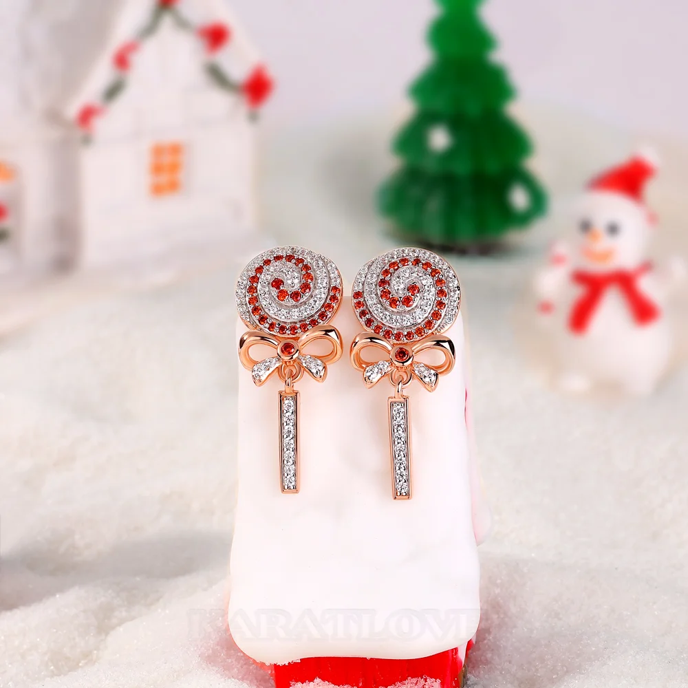 Boucles d'oreilles pendantes en argent sterling ornées de diamants blancs et rubis taille ronde avec un motif sucette et nœud