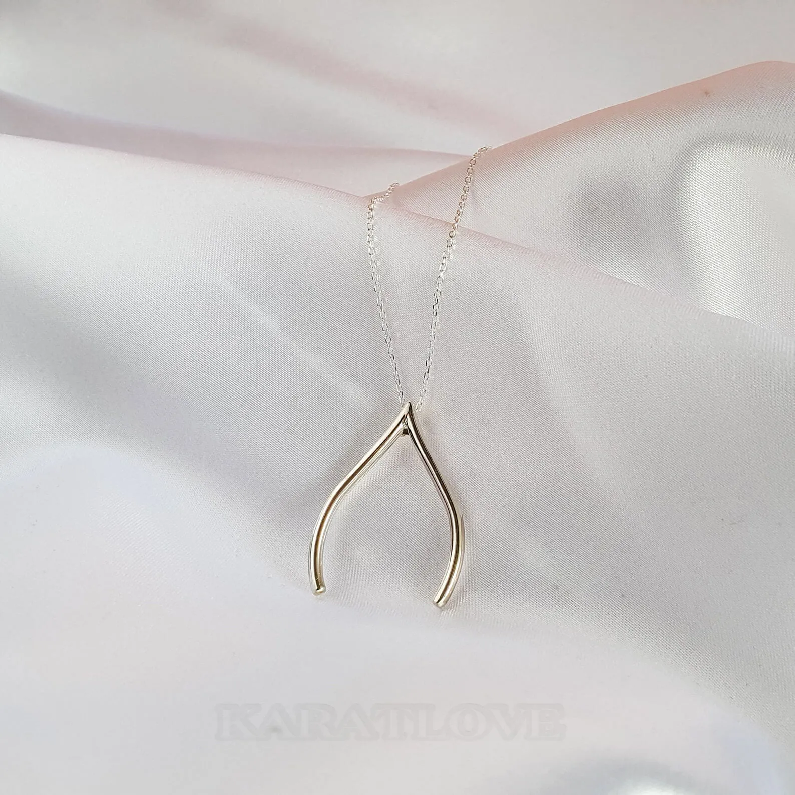 Collier avec pendentif en forme d'épingle à nourrice et de porte-bonheur
